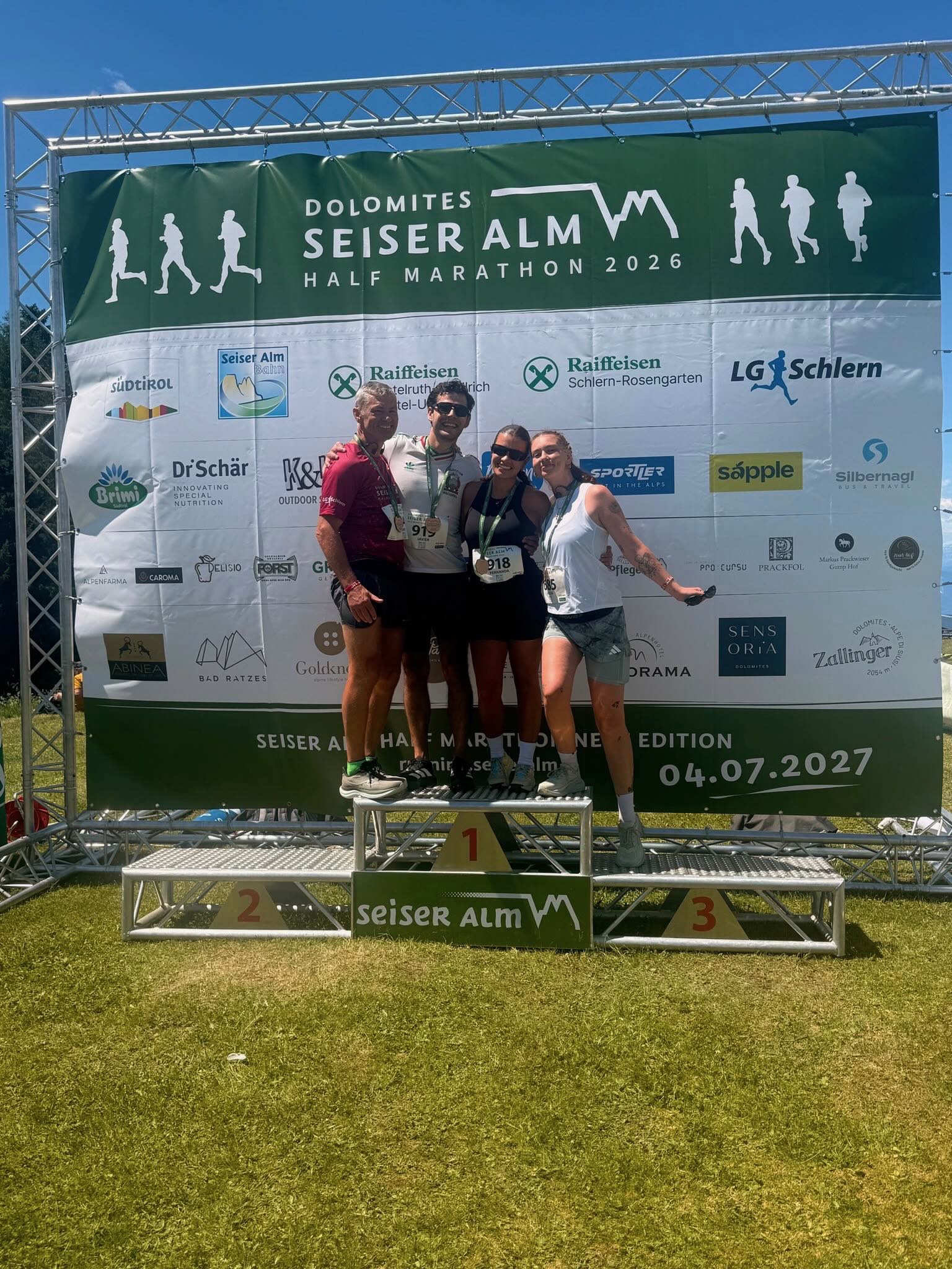 Alicia and Gary and two friends on the finish podium